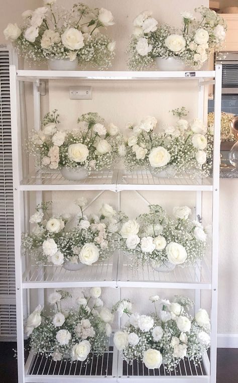 Baby's breath and white flower wedding centerpieces all lined up. White Rose Centerpieces, 2023 Weddings, Wedding Flower Trends, White Roses Wedding, White Wedding Theme, Rose Centerpieces, Floral Trends, Wedding Floral Centerpieces, White Wedding Flowers