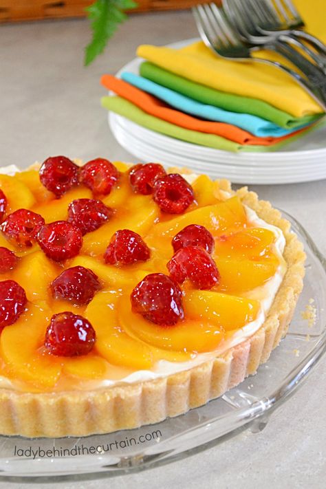 Peaches and Cream Tart. This incredibly pretty dessert starts with a delicious crust made from ground almonds and macaroon cookies. The filling is just as Cheesecake Recipes Mini, Bake Cheesecake Recipes, No Bake Cheesecake Recipes, Peach Tart Recipes, Layered Cheesecake, Cream Tarts, Flavored Cream Cheeses, Peach Cheesecake, Peach Tart