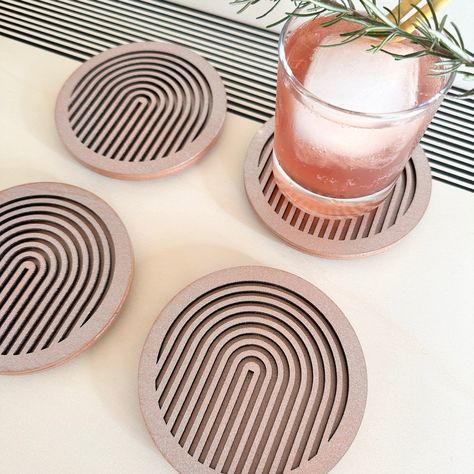 Introducing our set of 4 copper geometric coasters, perfect for protecting your furniture while adding a touch of modern style to any room. Each coaster is lovingly handmade in Milton Keynes, England from sustainable plywood and laser cut to create a unique and striking design.Our coasters are crafted from two pieces of wood, with the top layer featuring a geometric cutout design and the bottom layer left plain black. Each coaster is approximately 11.5cm in diameter and 8mm thick (plus extra for Beautiful Drinks, Copper Coasters, Laser Cut Coaster, Geometric Coaster, Laser Cut Decor, Modern Coasters, Cool Coasters, Laser Cut Wood Crafts, Laser Engraved Ideas