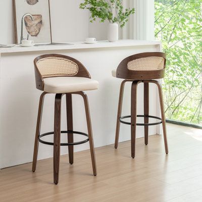 Presenting this versatile vegan leather swivel stool, designed to enhance dining rooms and bar counters. The stools are inspired by mid-century modern aesthetics and the rattan backrest blends vintage charm with contemporary beauty. The swivel seat design ensures convenience and ease of movement, ideal for social gatherings or daily meals. The armless design maximizes flexibility and space efficiency. Built with solid bentwood legs and a footrest, this stool set ensures stability and durability, Bar Stools Wood, Mid Century Bar Stools, Bar Counters, Space Efficiency, Rattan Counter Stools, Counter Stools With Backs, Mid Century Modern Bar, Rattan Bar Stools, Island Stools