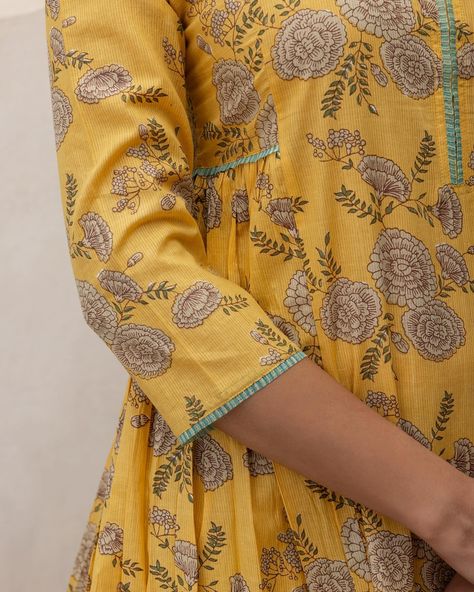 Summer 2024 - New Arrivals! Sunny vibes and a summer high... Our Sage Zinnia Kurta is all about embracing the joys of the season. Beautiful sage-coloured flowers lie in contrast to a bright mango yellow base accentuated with printed doria trims. [ Cottons Jaipur, New Arrivals, Cotton, Floral, Handmade Kurtas, Everyday-wear, Summer staples ] #cottons #cottonsjaipur #newarrivals #floral #summer #summer2024 #handcraftedkurtas #comfortfits #cottonsuitset #summertime #summerstaples #summerflor... Cottons Jaipur, Kurti Sleeves, Mango Yellow, Kurti Sleeves Design, Desi Outfits, Sunny Vibes, Salwar Designs, Beautiful Dress Designs, Sage Color