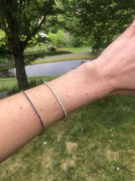 A tennis bracelet is not, in fact, a bracelet that you wear while playing tennis. It is actually a type of jewelry that gets its name from one of its most popular wearers: tennis superstar Chris Evert. So how did this sparkling piece of jewelry get its name? https://alexisjae.com/blogs/the-glistener/why-is-a-tennis-bracelet-called-a-tennis-bracelet #tennisbracelet #diamondtennisbracelet #tennisbracelets #historyoftennisbracelet #didyouknow #funfacts Blue Tennis Bracelet, Sapphire Tennis Bracelet, Eternity Bracelet, Work Capsule, Armband Tattoos, Diamond Bracelet Design, Tattoo Bracelet, Diamond Choker, Diamond Jewelry Designs