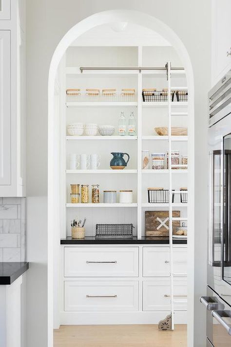 Arched doorway into a custom pantry featuring a ladder on rails on a built-in shelf with black quartz countertops. California Traditional Home, Traditional Interior Design, Butler's Pantry, Pantry Design, Studio Mcgee, Modern Country, Open Kitchen, White Cabinets, Interior Design Studio