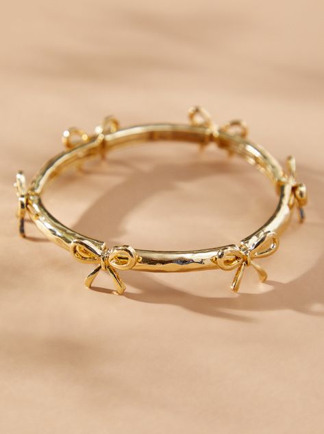 This delicate gold bow bracelet adds a touch of girly to your wrist. The gold bows stand out and the stretchy band ensures a comfortable fit for all-day wear. Dress it up or down, this bracelet is a versatile addition to any jewelry collection. Yellow Gold Bracelet Stack, Tiffany And Co Gold Jewelry, Jelewry Gold, Cute Jewelry Gold, Jewlary Pic Gold, Ring Inspo Gold, Enroute Jewelry, Bracelet Stack With Watch, Enewton Bracelets Stacks