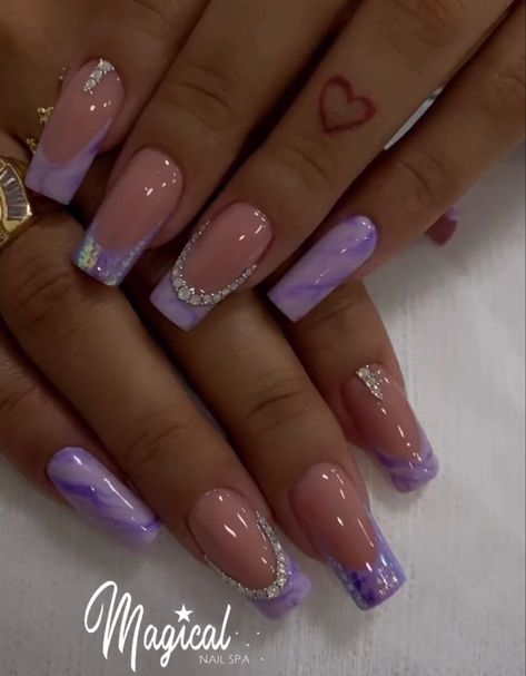 After fur nails, you probably thought that you had seen all the craziest nail art ideas. Purple French Tip Design, Purple Nail Art Designs Lavender, Nail Ideas Purple Lavender, Purple Coffin Nail Ideas, Lavender Nails With Glitter, Acrylic Nail Designs With Rhinestones, Short Purple Nail Designs, Lavender Nail Ideas, Purple Nails With Glitter