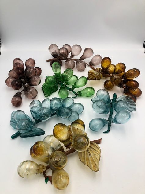 "Great news! All orders from my shop that total $35 or more get free shipping to the US!! Check out the rest of my shop to mix and match items: https://themagicwithin.etsy.com This listing is for your choice of beautiful hand-blown glass grapes. These grapes were commonly sold in Italy in the 1960's. Grapes range between 1\" to 2\" each. Each leaf measures about 2-1/2\". They are wrapped with floral tape that is a little tacky in places. Amber Glass - 11 grapes, 2 leaves Blue Glass - 5 grapes, 2 leaves Blue Glass - 12 grapes, 2 leaves Green Glass - 7 grapes, 2 leaves Purple Brown Glass - 8 grapes, 2 leaves Purple Brown Glass - 12 grapes, NO leaves Yellow Glass - 9 grapes, 2 leaves Actual coloring may vary slightly due to lighting, camera and monitor settings. Please Note: All of the items Blown Glass, Hand Blown Glass, Glass Grapes, Floral Tape, Reduce Reuse Recycle, Reduce Reuse, Reuse Recycle, Amber Glass, Beautiful Hand