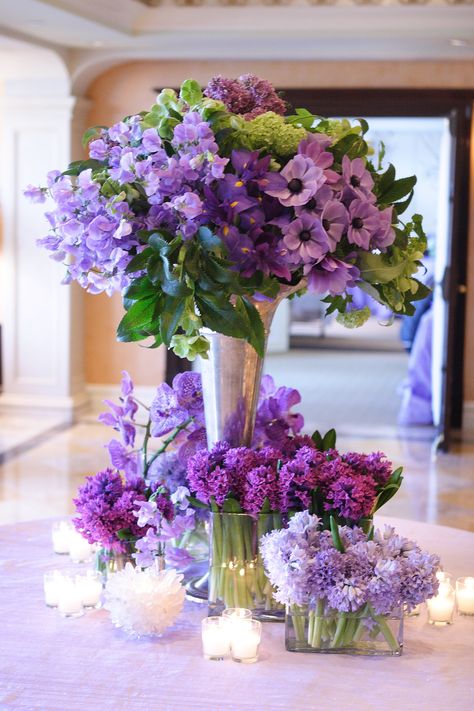 AN entry table to a Bat Mitzvah, full of different types of flowers in shades of purple and lavender including anemones, sweet peas, and hyacinth. Designed by KD&J Botanica. Photo by Neil Landino. #purpleflowers #anemone #sweetpea Hotel Flower Arrangements, Purple Flower Arrangements, Purple Centerpieces, Westport Connecticut, Hotel Flowers, Luxury Flower Bouquets, Purple Wedding Theme, Floral Design Studio, Memorial Flowers