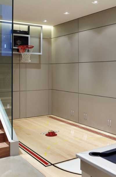 27 Indoor Home Basketball Court Ideas | Sebring Design Build Indoor Basketball Court In House, Basketball Garage, Indoor Sports Court, Home Basketball Court, Gym Space, Basketball Court Backyard, Indoor Basketball Hoop, Outdoor Basketball Court, Basketball Room