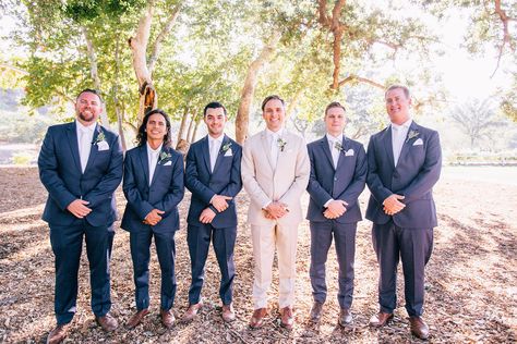 Groom In Tan Groomsmen In Navy, Beige Groom Navy Groomsmen, Tan Groom With Grey Groomsmen, Tan Groom Navy Groomsmen, Navy And Tan Groomsmen, Groom Tan Suit Groomsmen Navy, Navy Blue And Tan Groomsmen Suits, Tan Suit For Groom, Tan And Blue Groomsmen Attire