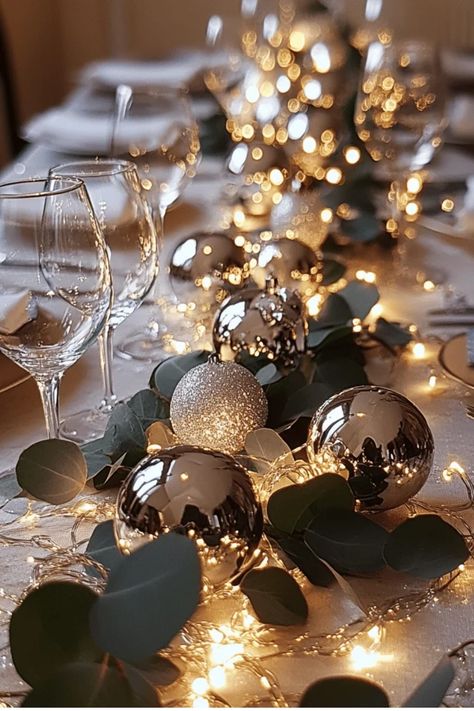 Create a stunning table runner with ornaments, greenery, and fairy lights. This versatile centerpiece adds a touch of elegance to any holiday gathering. Get the full tutorial now! Some of the links in my articles are affiliate links. If you make a qualified purchase from one of my links I will make a small commission at no cost to you. Thank you for your support!!! Table Setting With Fairy Lights, Christmas Table With Poppers, Ornament Table Runner, Hunter Green Christmas Table Decor, Christmas Table Greenery, Xmas Centerpieces Dinner Tables Elegant Christmas, Christmas Table Candle Centerpieces, Christmas Centerpieces Ornaments, Christmas Table Simple Decor