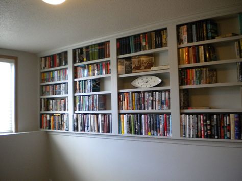 My Bookshelves are done! Entire wall above the ledge in lower level spare bedroom can now hold books. Thank you to SOS Carpentry in Fargo, ND! Half Wall Library Shelves, Built In Shelves Living Room Half Wall, Basement Half Wall Ledge Decorating Ideas, Wall Ledge In Bedroom, Ledge Wall Basement, Basement With Ledge Half Walls Decor, Ledge Around Basement Wall, Rooms With Ledges All Around, Half Shelf Wall