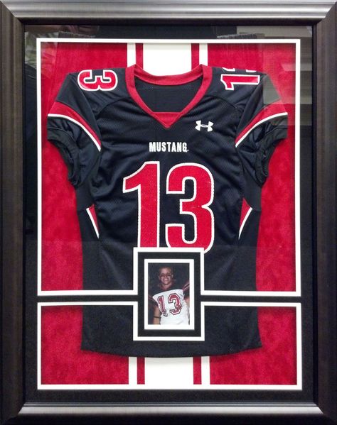 This football jersey is mounted on inlaid mats and is completely reversible. Our custom framing departments can mount jerseys and other sports memorabilia with industry-approved methods. Frame Jersey Ideas, Sports Shadow Boxes, Sports Jersey Display, Sports Pictures Display, Football Jersey Frame, Jersey Display Case, Football Diy, Jersey Display, Baseball Teams