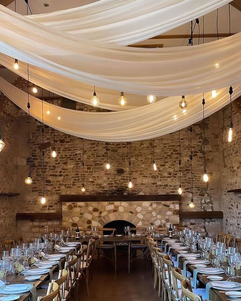 Ivory Draping X Drop Festoons.. 🎀💡 This has to be on of our favourite lighting and draping combinations at the stunning @pentneyabbeyestate | @uniquenorfolkvenues #wedding #weddingday #realwedding #weddinglighting #weddingdecor #weddingstyling #weddingtrends #weddinginspo #weddinginspiration #weddingvenue #weddingdraping #draping #drapingdesigns #norfolkwedding #wedding2024 Wedding Drapes And Lights, White Drapes Wedding Reception Ideas, Wedding Venue Lights Ceilings, Chiffon Ceiling Draping, Barn Draping Wedding, Wedding Draping Ceiling, Wedding Decor Draping, Ceiling Drapes Wedding, Draping Wedding Reception