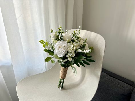 "Petite White Rose Wedding Bouquet 10\"/ Mini Hand-tied White Rose & Eucalyptus Bouquet/ Classic Small White Rose Greenery Bouquet/ Small Simple Wedding Bouquet/ Tiny Rustic Wedding Bouquet Petite white rose wedding boquet, which is classic and elegant.  Best choice for a simple and romatic wedding ceremony. Bridal bouquet at size 10 inches width. Bridesmaid bouquet at 6 inches width. I am using the top quality silk flower and eucalyptus on my work, that the bouquet looks very realistic and stunning.  Coordinating boutonnieres and corsages are available. If you need any matching archway, swag and tieback, garland, cake topper, centerpieces or hairpieces, please message me for a quote. Tailor made service are available, please send me your ideas for a quote. Jump to my shop here:  https://w Roses Only Bouquet, Courthouse Wedding Bouquet Simple, Affordable Bridesmaid Bouquet, Small White Roses Bouquet, Mini White Rose Bouquet, Small Green Bouquet, White And Green Winter Wedding Bouquet, 3 Flower Bouquet Simple, March Bridal Bouquet