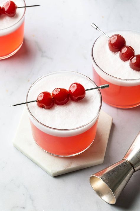 Cherry vodka sour is fresh, frothy and tangy cocktail that's perfect for summer. It has a light and bright taste with a creamy finish, thanks to the egg white in the recipe. The pretty pink hue of the cocktail garnished with cherries makes it perfect to serve for your next summer holiday get together! Cherry Vodka Drinks, Vodka Sour Recipe, Cherry Vodka Sour, Vodka Sour, Vodka Cocktails Easy, Cherry Drink, Cherry Vodka, Cherry Cocktail, American Desserts