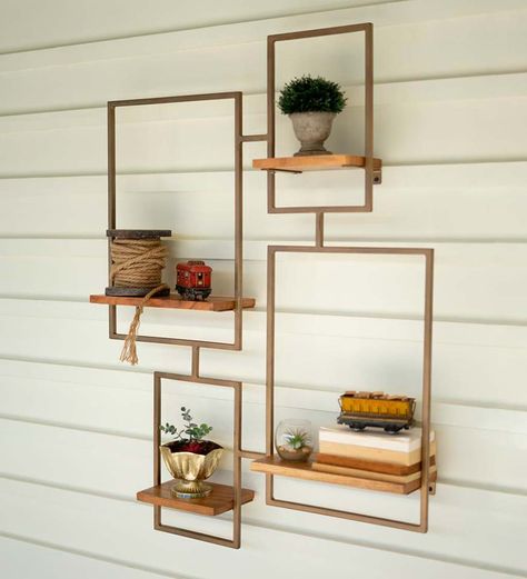 The luminous matte gold finish sets off the chic contemporary frame design of this wall shelf. Position your favorite knickknacks, succulent plants or books on the four wood surfaces for a look that's all your own. The gold metal frame outlines the shelf like a window box and the salvaged wood plank shelves are left natural for a refined yet weathered look. This large-scale shelving unit makes a beautiful showstopper in your entry wall or living room. V5419,Gold Statement Shelves, Wood Plank Shelves, Wall Mounted Shelving Unit, Wall Unit Designs, Wall Shelf Unit, Tiered Shelf, Shelf Decor Living Room, Modern Organization, Wall Shelving Units