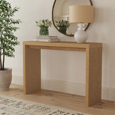 The Jasper minimalist console table with a waterfall edge design makes a one-of-a-kind statement piece for your living space. The sleek rectangular table is hand finished in timeless black or light natural wood stain. The angular, clean lines of the console's silhouette has tapered detailing making a feature of the fine craftsmanship and organic wood tones. The versatile style of this console is at home in modern, industrial and transitional living rooms, dining rooms or entryways. Color: Brown Modern Waterfall Console Table, Console Table Wood Modern, Diy Modern Console Table, Console Table Small, Wood And Metal Furniture, Minimalist Console Table, Egypt Sherrod, Waterfall Console Table, Natural Wood Stain