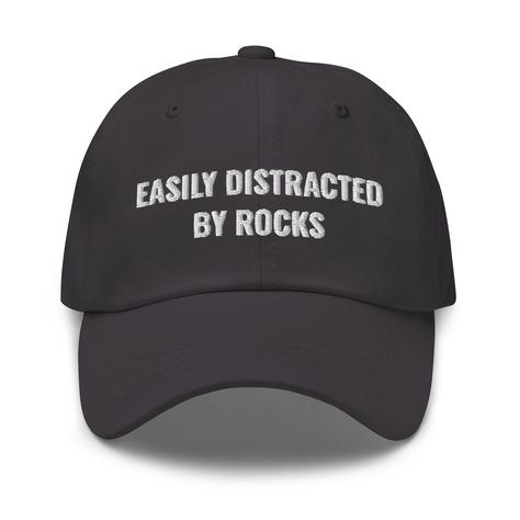 Easily Distracted By Rocks Hat, Geology, Geology Hat, Geology Gifts, Geologist Student, Geology Student Gifts, Dad Hat Adjustable Cap Dad hats aren't just for dads. This one's got a low profile with an adjustable strap and curved visor. * 100% chino cotton twill * Green Camo color is 35% chino cotton twill, 65% polyester * Unstructured, 6-panel, low-profile * 6 embroidered eyelets * 3 ⅛" (7.6 cm) crown * Adjustable strap with antique buckle * Blank product sourced from Vietnam or Bangladesh Silly Clothes, Silly Hats, Funny Hats, Easily Distracted, Funny Outfits, Camo Colors, Green Camo, Dad Hat, Student Gifts