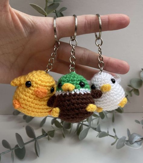 Introducing our adorable Crochet Duck, Chick, and Mallard Keyring Set! These charming little companions are handcrafted with love, making them the perfect accessory to accompany your keys or adorn your bags. Each keyring features intricate crochet work, adding a touch of whimsy and uniqueness to your everyday essentials. The vibrant colours and meticulous detailing truly bring these crochet creatures to life. Whether it's the cheerful yellow duck, the adorable fluffy chick, or the striking mallard, these keyrings are sure to capture attention and spark conversation. Not only are these keyrings undeniably cute, but they are also highly functional. The sturdy keychain ensures that you won't lose your keys, while the compact size allows for easy transportation. Whether you're a bird lover, a Crochet Creatures, Desk Pet, Plushie Amigurumi, Crochet Duck, Duck Bag, Crochet Ball, Crochet Monsters, Crochet Octopus, Crochet Keychain Pattern