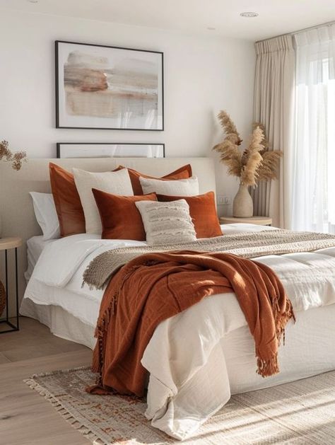 Transform your bedroom with stunning orange decor! From cozy and rustic to modern and bold, discover creative ideas that add warmth and energy to your space. Whether you love vibrant accents or subtle tones, these home decor tips will inspire a stylish and inviting bedroom makeover. Explore our collection and find the perfect orange-themed decor to elevate your bedroom today! White Bedding Rust Accents, White Bedroom With Orange Accents, Grey Burnt Orange Bedroom, Burnt Orange Apartment Decor, Apartment Autumn Decor, Burnt Orange And White Bedroom, Cream And Orange Bedroom, Cream And Rust Bedroom, Modern Cozy Home Decor