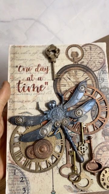 Robertson Artistry by Vishal | Mixed Media & Jewellery on Instagram: "One day at a time... This inspirational diary is just the motivation you need for those rough days.⠀ ⠀ I created this steampunk themed journal after find in a a matching decoupage paper from @itsybitsycraftstore to the resin dragonfly mould from @craftadda. This journal that can be used as a notebook, diary, for scrapbooking and sketching. It is an A5 journal with 64 blank pages.⠀ ⠀ DM me for more details. ⠀ #mixedmediajourn Steampunk Journal Cover, Steampunk Junk Journal Ideas, Steampunk Journal Pages, Punk Journal, Resin Dragonfly, Steampunk Scrapbooking, Recycled Fabric Art, Steampunk Junk Journal, Steampunk Journal