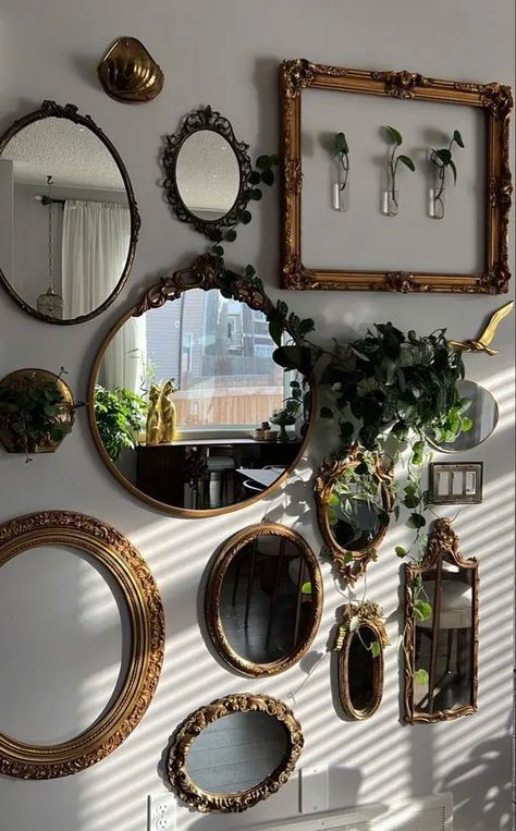 a blank wall done with a mirror gallery wall, with empty frames, greenery and some vases on the wall is amazing Practical Apartment Decor, Living Room Wall Decor Ideas Maximalist, Refined Home Decor, How To Make A Modern House Look Vintage, House Decor Unique, Simple Home Wall Decor, Dark Maximalism Apartment, Colorful Vintage Home, Practical Magic Aesthetic Home Decor