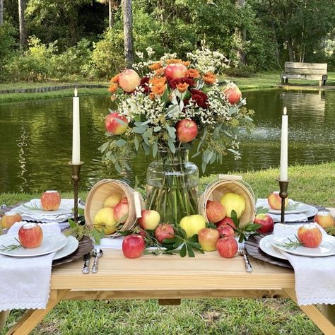 This beautiful apple harvest tablescape is the perfect way to welcome the arrival of Autumn. Lots of apples, a beautiful floral arrangement, and apple votive candles holders all create a unique, fun, and festive way to celebrate the season. Find all the details on the blog. Apple Bridal Shower Ideas, Apple Table Decorations, Harvest Tablescape, Apple Theme Parties, Fall Festival Party, Apple Centerpieces, Apple Table, Apple Orchard Wedding, Fall Tea