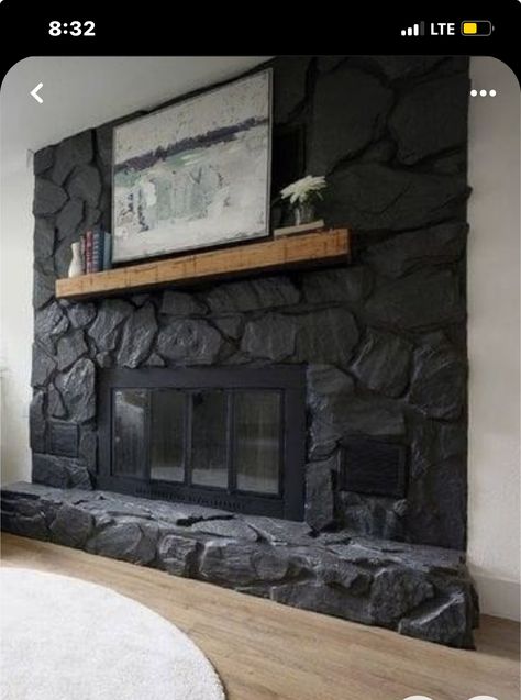 Painting Rock Wall Fireplace, Black Rock Wall Fireplace, Black Stone Corner Fireplace, Dark Wash Fireplace, Rock Chimney Makeover, Black Stone Fireplace Living Room, Grey Painted Rock Fireplace, Over Grouted Stone Fireplace Before And After, Black Stone Fireplace Modern