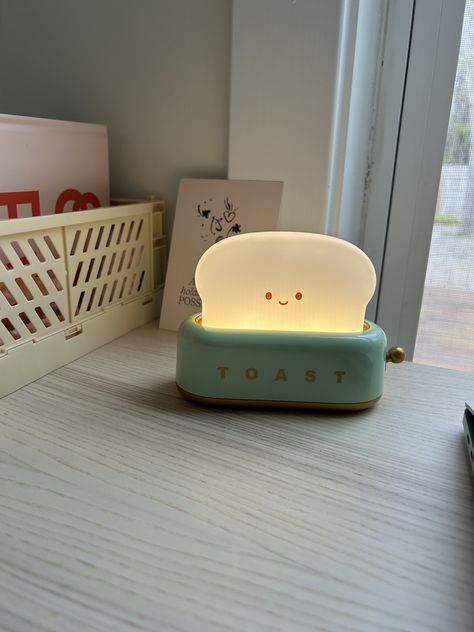 Work mode "ON" with the cutest mini companion, TOAST table lamp. The lamp has a soft yellow light and the ambience can be regulated with the mini golden handle. it comes with the charger cable and is available in three other colors on Amazon! A fun addition to your desk or baby room. #ambientlight#stationary#deskdesign#homedesign#lighting#cute#Amazon Cute Toaster, Green Toaster, Bread Cute, Creative Desks, Toast Bread, Small Lamps, Desk Decorations, Light For Bedroom, Small Lamp