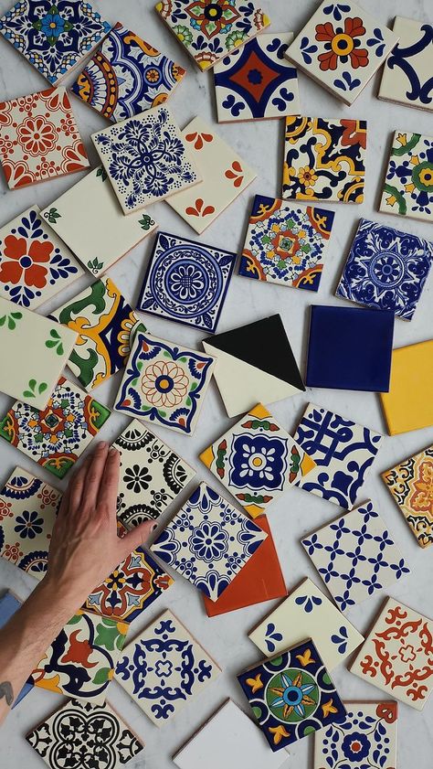 Hand-Painted Tiles1 Colorful hand-painted ceramic tiles laid out on a marble surface, featuring intricate traditional designs. | Sky Rye Design