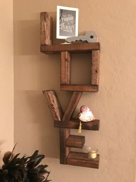 I saw this shelf on Pintrest a while ago and wanted to make it. As soon as the season for Valentine's was coming , I started the shelf. I decided I wanted to make a few at a time. As I'm sure I'd sell or use them as gifts. I asked by Hubby to help. On Friday, I drew up various designs based off of pictures of various LOVE shelves that I had seen. Then, I decided how tall I wanted the shelf to be and came up with the other dimensions. I had a wood pall… Love Shelf, Valentine Wood Crafts, Wooden Greenhouses, Wood Projects That Sell, Diy Holz, Wood Crafts Diy, Wooden Planks, Into The Woods, Wood Gifts