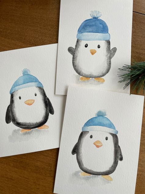 Description: Bring a touch of charm to your holiday greetings with this adorable winter penguin watercolor card! This 5x7 card features a hand-painted watercolor illustration of a cute penguin wearing a cozy blue hat, making it perfect for spreading warmth and joy during the holidays. Key Features: ❄️Original Watercolor Art: Each card showcases a unique, hand-painted winter penguin, ensuring that no two cards are exactly alike. ❄️Perfect for the Holidays: Ideal for Christmas, winter celebrations, or any festive occasion. ❄️Blank Inside: Plenty of space for your personalized message, making it suitable for various occasions. ❄️Quality Materials: Made with premium Strathmore watercolor paper for a beautiful and lasting finish. ❄️ White Envelope Included: Comes with a high-quality white envel Christmas Card Designs Watercolour, Christmas Cards Hand Made, Christmas Painted Cards, Easy Holiday Watercolor, Winter Painting Watercolor, Winter Cards For Kids, Mini Christmas Watercolor Paintings, Christmas Drawing Watercolor, Christmas Cards Acrylic Paint