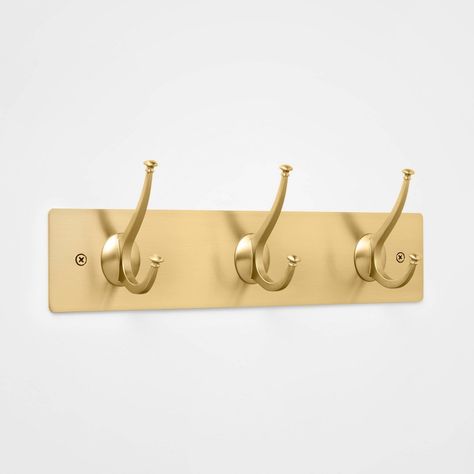 Organize your space in glam style with this New Traditional 3-Hook Rail from Threshold™. Whether you use this stylish wall hook rack in your living room, bedroom or bathroom, it will stand out thanks to its unique design, which includes three curved gold-tone metal hooks arranged on a gleaming rectangular metal base with a complementary gold-plated finish. This three-hook rack conveniently mounts on any wall and helps create a quick, easy and space-saving spot to hold a wide variety of items, su Gold Towel Hooks, Ikea Dorm, Towel Hook Bathroom, Nautical Shower Curtain, Wall Hook Rack, Coastal Room, Beach Room, Bedroom Items, Preppy Room Decor