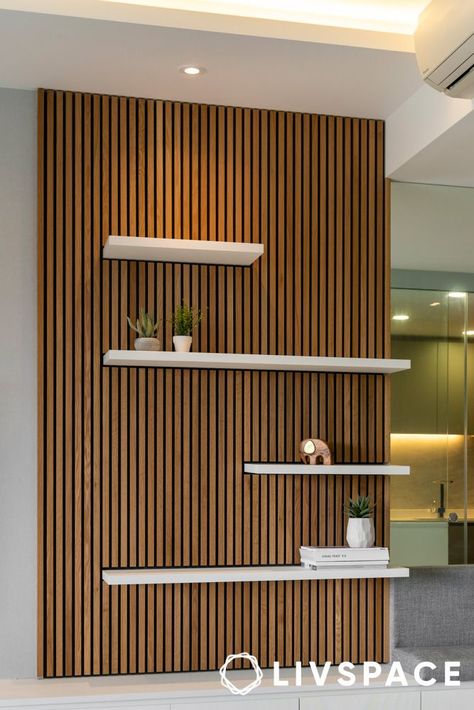 wooden-panel-design-that-also-works-as-display-unit Wood Accent Walls Living Room, Office Slat Wall, Living Room Wood Panel, Display Units Living Room, Wood Panel Accent Wall, Accent Wall Shelf, Wooden Partition Design, Wooden Panel Design, Panels For Walls