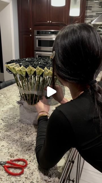 302 FLOWERS 🌹 on Instagram: "The process of arranging a money rose bouquet 🖤💵 (50 black glitter roses + $50 in 1s) - - - Materials needed: • Wet foam • Clear wrap • Floral wrap • Tape • Bamboo skewers  • 1.5in Ribbon ANY QUESTIONS COMMENT DOWN BELOW 👇🏼 ✨ - - - #explore #fyp #explorepage #flowers #red #roses #rosebouquet #bouquet #romance #smallbusiness #lovethis #selflove #love #flowerarrangement #flowerarrangements #roselover #flowerlovers #romantic #bigbouquet #bigrosebouquet #glitter #softgirl #repost #share #follow #showlove #igreels #reelsinstagram #reels #blowthisup" Roses And Money Bouquet, Money Bouquet With Roses, Black Glitter Roses, Money Rose Bouquet, Black Rose Bouquet, Wet Foam, Black Bouquet, Money Rose, Black And Red Roses