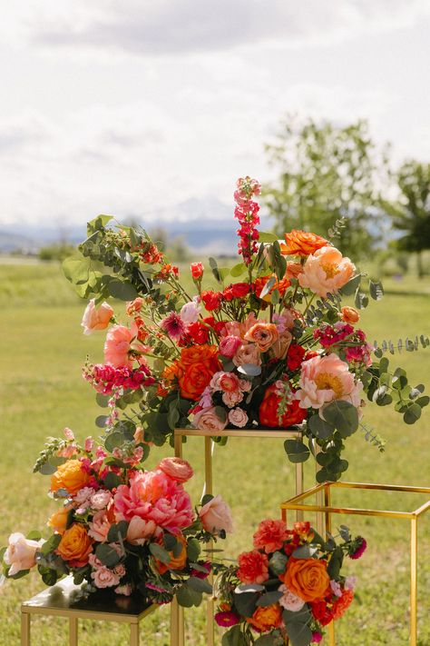 Colorful Wedding Florals at Yellowstone Ranch| Colorado Wedding Photographer | Just love these colorful wedding florals with pops of orange and pink! These were unique luxury wedding florals that really popped against the mountain ceremony backdrop at Yellowstone Ranch. Get inspired by luxury wedding florals, outdoor ceremony decorations, colorful wedding schemes, Colorado mountain wedding venues, and more. Book Logan as your Colorado wedding photographer at mrsferreephotography.com! Montana Wedding Colors, Spring Colorado Wedding, Colorful Western Wedding, Summer Mountain Wedding Decor, Spring Wedding In Colorado, Outdoor Ceremony Decorations, Wild Flower Mountain Wedding, Yellowstone Wedding, Mountain Ceremony