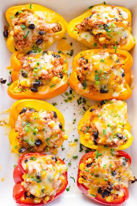 Mexican Stuffed Peppers with flavorful ground turkey, rice, corn and black beans baked inside colorful bell peppers with melted cheese on top. So delicious and easy! You need to make these! Stuffed Bell Peppers Turkey, Ground Turkey Rice, Corn And Black Beans, Beans Baked, Ground Turkey Stuffed Peppers, Baked Peppers, Mexican Stuffed Peppers, Stuffed Peppers With Rice, Turkey Rice