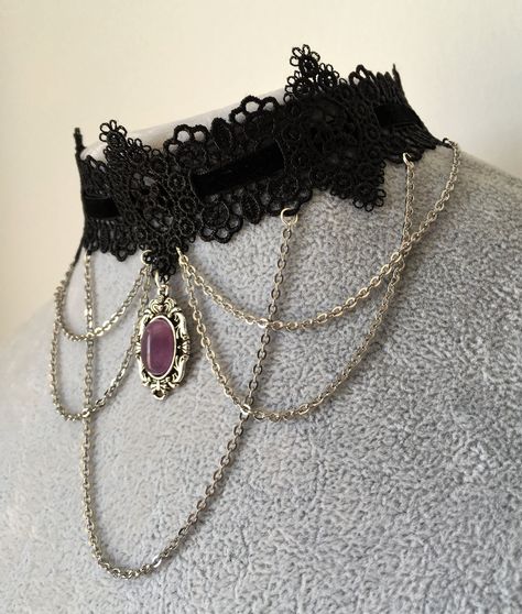 Black lace and velvet gothic choker featuring a silver chains design and an amethyst gem pendant in the middle. Lace is 4cm in the widest part. This piece fastens with a clasp and 5cm chain at the back. It is to fit neck sizes from 12 to 14.7 inches (31-36cm). If these measurements do not fit you, send me your measurements with your order. This choker is light and not heavy on th...#Timeless #the #A #Exploring #Fashion #Statement #of #the #Allure #The #of #Art #of #Choker #Tidiness #Necklaces Macabre Fashion, Chains Design, Gothic Choker Necklace, Gothic Choker, Goth Choker, Black Lace Choker, Gem Pendant, Choker Necklace Designs, Grunge Jewelry