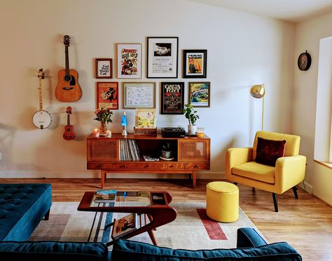 Mid Century Modern Living Room Gallery Wall, Gallery Wall Over Sectional, Retro Mid Century Modern Living Room, Gallery Wall With Instruments, Hang Instruments On Wall, Accent Gallery Wall Ideas, Instruments In Living Room, Living Room With Instruments, Apartment Accent Chairs