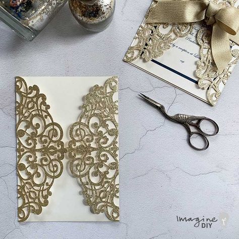 HOW TO MAKE … GLAMOROUS GOLD WEDDING INVITATIONS - Imagine DIY This glamorous DIY wedding invitation looks like it will break the bank. But in fact, you will barely even need to empty the loose change from your pockets to create these beautiful invitations at home. The navy border and gold sparkle ribbon really add a sense of chic to an already beautiful laser cut invitation.  The best thing about this design is that if you can tie a shoelace, you can make these with ease. Pocket Invitation, Laser Cut Invitation, Wedding Invitation Kits, Wedding Crafts Diy, Luxury Invitation, Laser Cut Wedding, Laser Cut Wedding Invitations, Invitation Kits, Lasercut Design