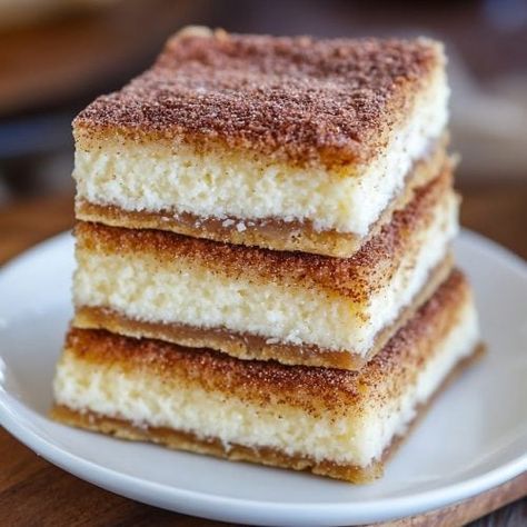 Super Easy Churro Cheesecake Bars Recipe Keto Churro Cheesecake Bars, Churros Cheesecake Bars, Margarita Bars Dessert, Dessert For Taco Bar Party, Mexican Potluck Ideas Desserts, Churro Cheesecake Tacos, Easy Mexican Dessert, Taco Night Dessert, Horchata Cheesecake