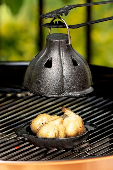 Roast bulbs of garlic on the grill or in the oven inside this Cast Iron Garlic Roaster to tame its harsh bite for a more sweet, savory, and spreadable flavor. Garlic Roaster, Roasted Garlic Cloves, Best White Elephant Gifts, Uncommon Goods, Best Stocking Stuffers, Quick Weeknight Meals, Unique Kitchen, Foodie Gifts, Kitchen Gifts