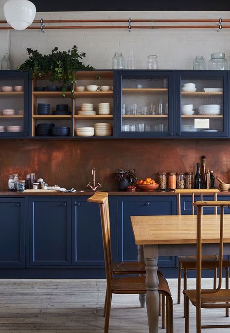 an impressive blue kitchen with a copper backsplash and a rich stained wooden countertop feels refined and vintage inspired Celebrity Kitchens, Kitchen Color Schemes, Navy Blue Kitchen, Navy Kitchen, Copper Backsplash, Blue Kitchen Cabinets, Blue Cabinets, Blue Kitchen, Copper Kitchen