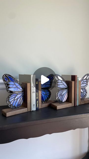 kel | camel city glass on Instagram: "Two new butterfly bookend sets were added to the roster this morning!🦋Whether you have three books or a double digit collection you want to show off, these sets were made to hold it all together and be a stunner at the same time🤩Which of these two do you like best? I gravitate towards the blue set but then that iridescent glass on the purple set catches the sun and I’m sold😍  Just a few more days until these are all released. I’ll give you an “all in one” view of all 12 sets tomorrow!  #glassbutterfly #bookends #instagramreaders #currentlyreading #bookshelfdecor" Butterfly Book Ends, Butterfly Bookends, Butterfly Books, Purple Set, Glass Butterfly, Bookshelf Decor, The Purple, Butterfly Wings, This Morning