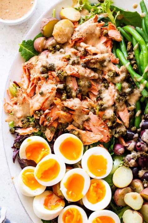 A delicious variation on the classic tuna Niçoise salad, this version includes tender salmon, crispy tender green beans, hearty potatoes and a delicious dressing that takes the salad to the next level. Paleo with a Whole30 option, this salad is sure to become a new favorite. #paleo #whole30 #cleaneating #salad #salmon Supperclub Ideas, Salmon Nicoise Salad, Salmon Crispy, Tuna Nicoise Salad, Salad Salmon, Hot Bacon Dressing, Paleo Salmon, Paleo Running Momma, Light Cooking