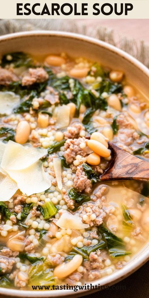 This Escarole Soup recipe is a comforting blend of Italian sausage, cannellini beans, and escarole greens in a flavorful chicken stock base. It's a hearty and soul warming dish that is easy to prepare. Sausage And Escarole Soup, Chicken Escarole Soup, Bean And Escarole Soup Recipe, Sausage Escarole And Bean Soup, Sauteed Escarole, Escarole And Beans Soup, Italian Escarole And Beans, Escarole And Bean Soup, Escarole Recipes