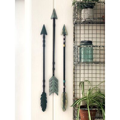 These handmade tribal arrows are truly unique in their design with each one having its own originality. Priced as a set of three they can be placed in many different settings, bringing versatility in decorating and adventurous thoughts to one's mind. | Loon Peak® 3 Piece Tribal Arrows Wall Décor Set 22.0 H x 2.0 W x 0.5 D in / grayMetal in Black | 22" H X 2" W | Wayfair Arrow Decor Ideas, Western Wall Decor Bedroom, Arrows Wall Decor, Arrow Artwork, Turquoise Wall Decor, Chevron Wall Decor, Deer Head Wall Decor, Travel Room, Adventure Decor