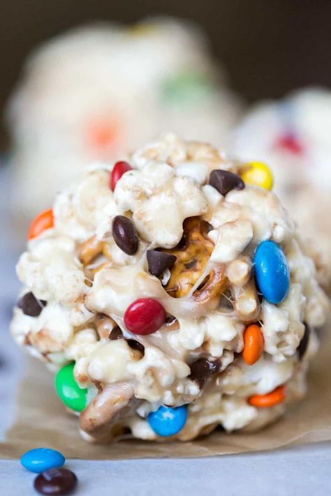 Popcorn ball on a sheet of brown parchment paper Popcorn Ball Recipe, Marshmallow Popcorn Balls, Fall Yummies, Popcorn Ball, Popcorn Balls Recipe, Marshmallow Popcorn, Kids Halloween Food, Salty Popcorn, Snack Mixes