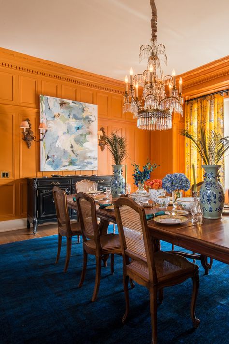 Vintage Hollywood Regency Decor, Eccentric Dining Room, Orange And Blue Dining Room, Orange Dining Room Walls, Orange Wall Dining Room, Maximalism Dining Room, Yellow And Orange Dining Room, Vintage Maximalist Dining Room, Orange Blue Interior