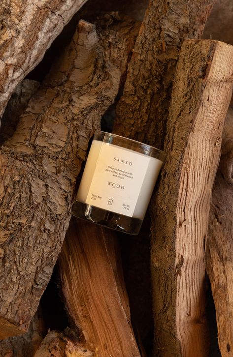 What it is: A woody and musky candle that seamlessly diffuses to create a signature scent personality in every room.Fragrance story: Santo Wood falls within the woody musk fragrance category and combines the highest quality materials sourced from the best growers in the world. Style: Woody, aromatic. How to use: Trim wick to 1/4" before each burn. Never leave candles unattended and don't burn for more than 4 hours at a time. When 1/4" of unmelted wax remains, discontinue use. 7.5 oz. Paraben-fre Luxury Candle Photography Ideas, Pf Candle, Brown Candle Aesthetic, Aesthetic Candle Photography, Fall Candle Photoshoot, Moody Candle Photography, Candle Ads, Holiday Candle, Candle Aesthetic Cozy Dark